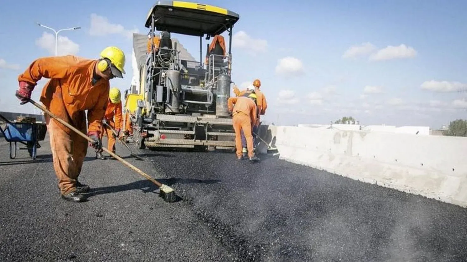 Kaplan Industry paving equipment applying asphalt on a road project